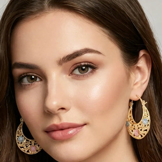 Gilded crescent-shaped earrings adorned with enamel flowers